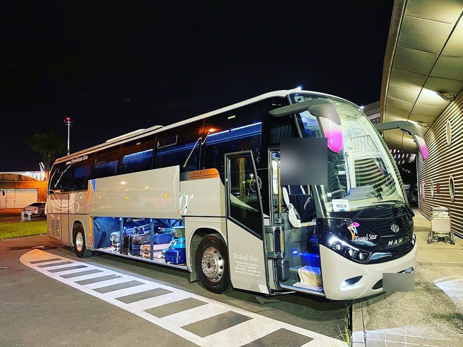 Autocar grand tourisme de la flotte Travel Star, à l'aéroport Pôle Caraïbes de nuit.